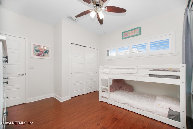 unfurnished bedroom featuring ceiling fan, a closet, and dark hardwood / wood-style flooring