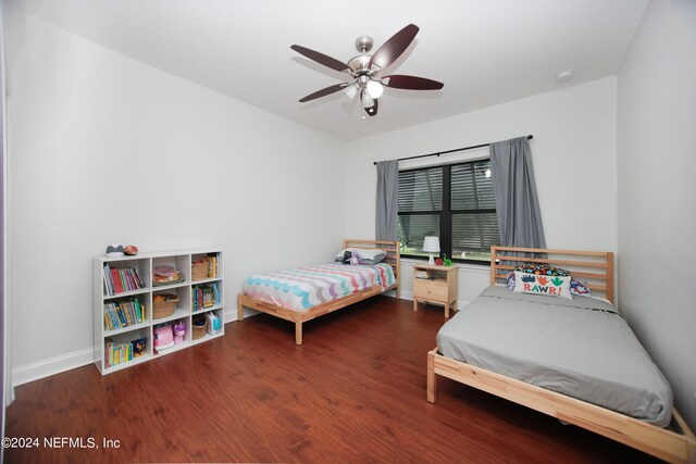 bedroom with ceiling fan and dark wood-type flooring