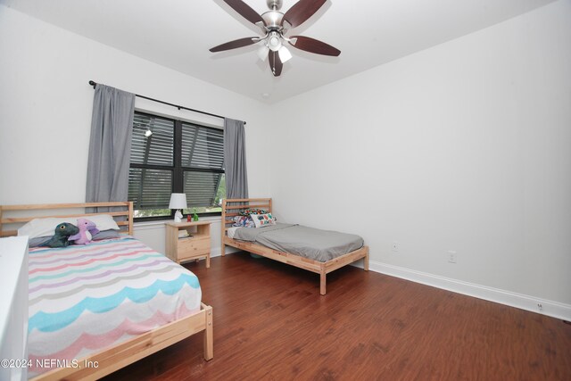 bedroom with ceiling fan and dark wood-type flooring