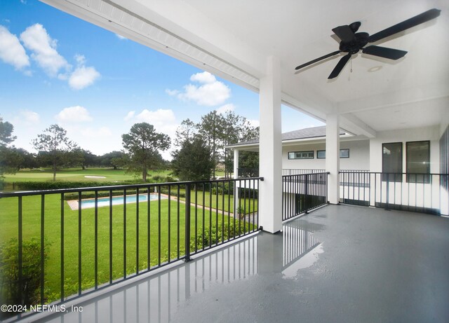 exterior space featuring ceiling fan and a balcony