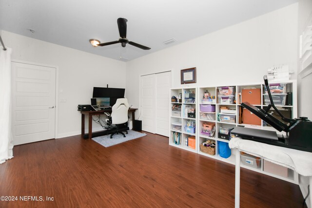 home office with ceiling fan and dark wood-type flooring