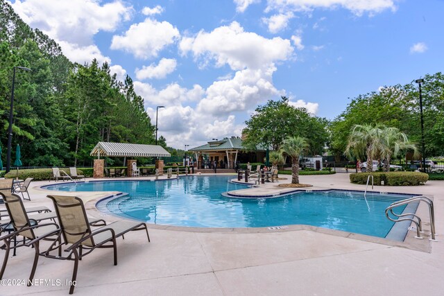 view of swimming pool with a patio