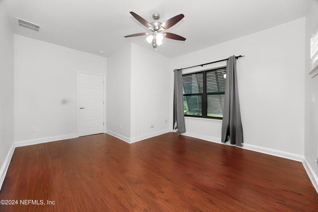 empty room with ceiling fan and hardwood / wood-style flooring