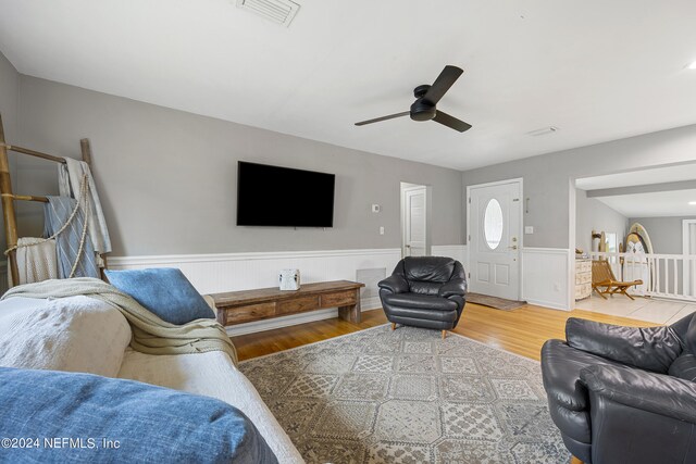 living room with ceiling fan and hardwood / wood-style floors