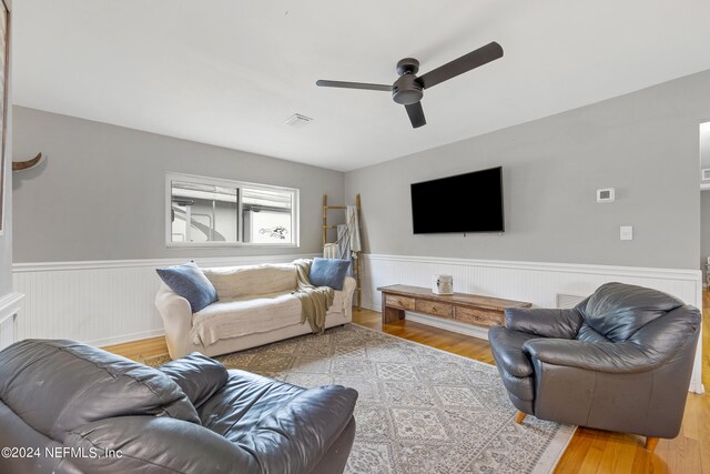 living room featuring light wood-type flooring and ceiling fan