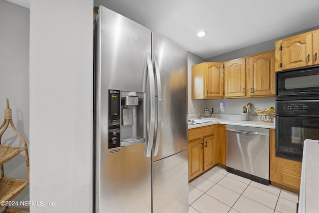 kitchen with black appliances and light tile patterned floors