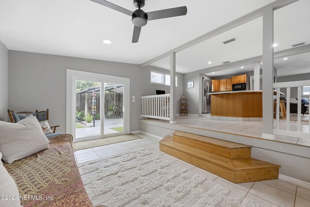 tiled living room featuring ceiling fan