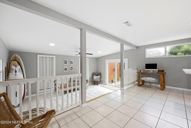 interior space with ceiling fan and lofted ceiling with beams