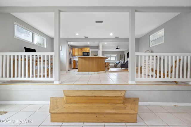 interior space featuring light tile patterned floors and a healthy amount of sunlight