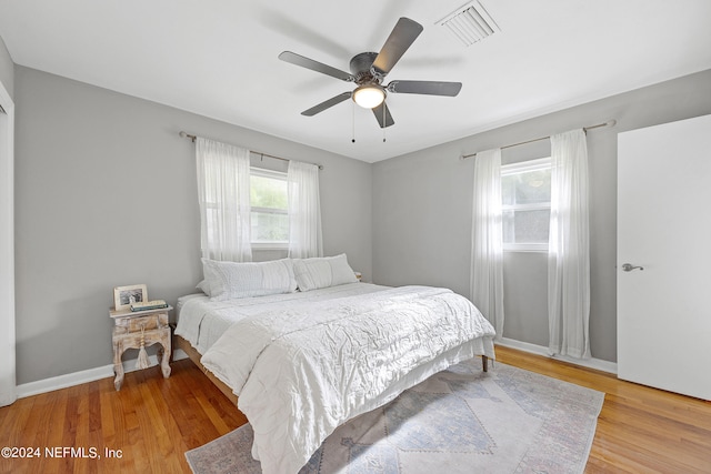 bedroom with ceiling fan and light hardwood / wood-style floors