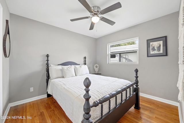 bedroom with ceiling fan and hardwood / wood-style flooring