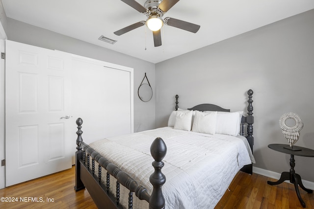 bedroom with dark hardwood / wood-style flooring and ceiling fan