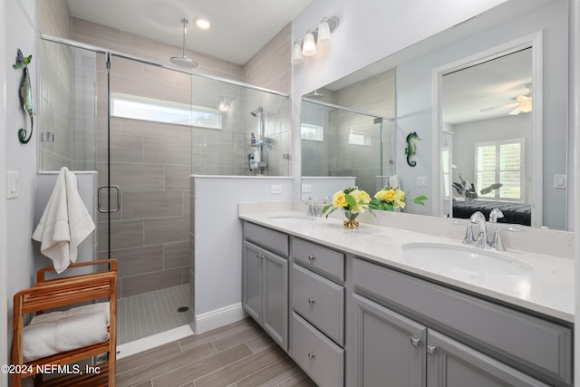 bathroom featuring vanity, ceiling fan, and an enclosed shower