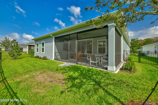 back of house featuring a yard, a sunroom, and a patio