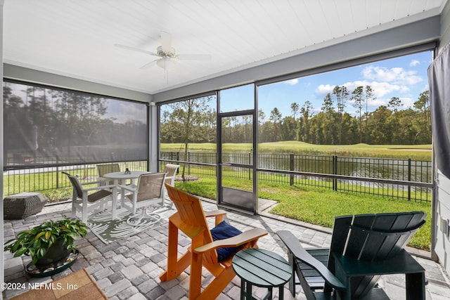 sunroom / solarium featuring ceiling fan