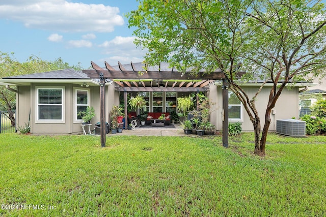 back of house featuring a lawn, a patio, and a pergola