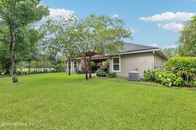 view of yard featuring a pergola and central AC