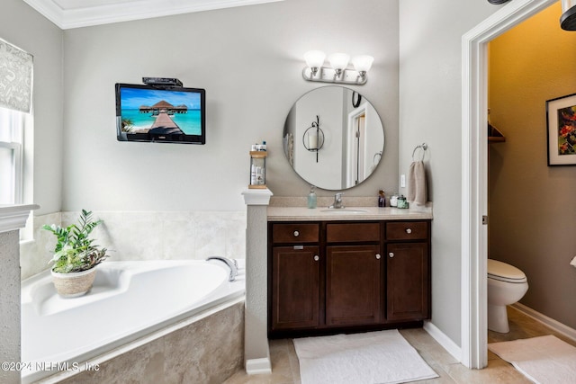 bathroom with tiled tub, vanity, crown molding, tile patterned flooring, and toilet