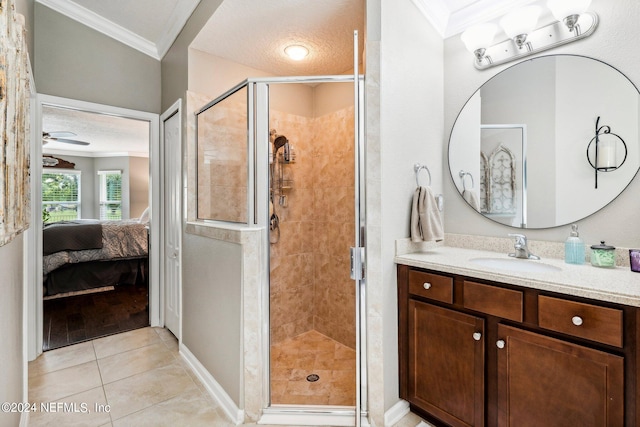 bathroom featuring ceiling fan, vanity, ornamental molding, an enclosed shower, and tile patterned floors