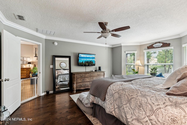 bedroom featuring a textured ceiling, dark wood-type flooring, and crown molding