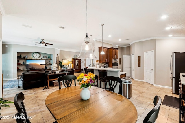 tiled dining room featuring ornamental molding and ceiling fan