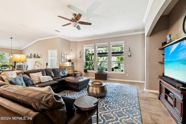 living room with ceiling fan, ornamental molding, and a wealth of natural light