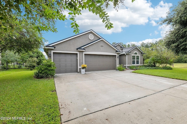 single story home featuring a front yard and a garage