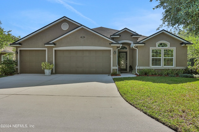 single story home with a garage and a front lawn