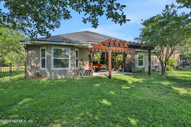 back of house with a pergola, a lawn, and a patio area