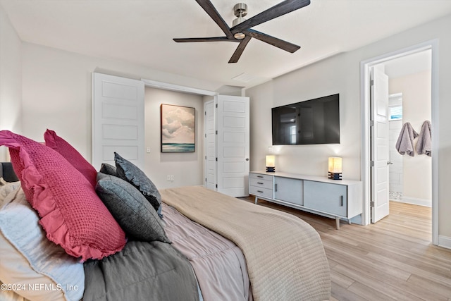 bedroom with ceiling fan, light hardwood / wood-style floors, and ensuite bath