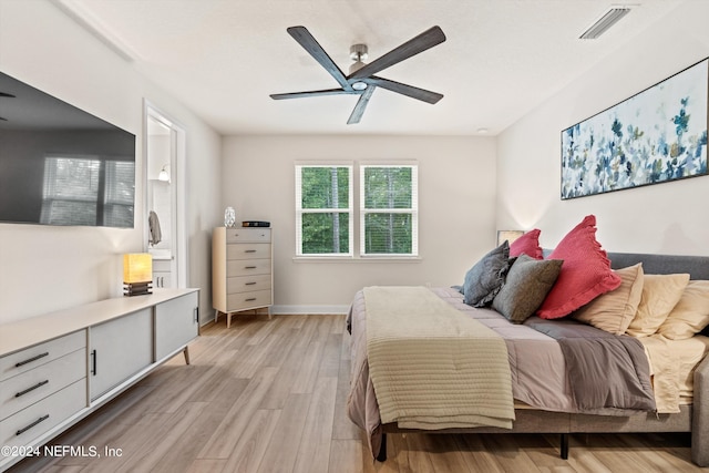 bedroom with light hardwood / wood-style flooring and ceiling fan