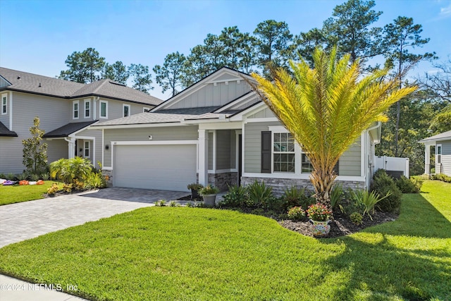 view of front of home with a garage and a front yard