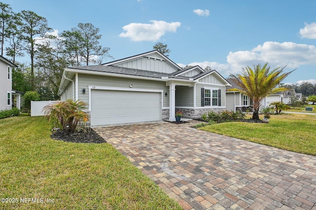 view of front facade with board and batten siding, decorative driveway, a front lawn, and an attached garage