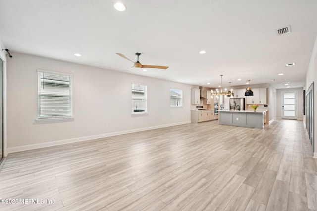 unfurnished living room featuring a healthy amount of sunlight, recessed lighting, and light wood-style floors