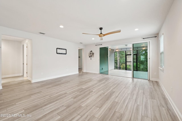 unfurnished room featuring light wood-type flooring, visible vents, and recessed lighting