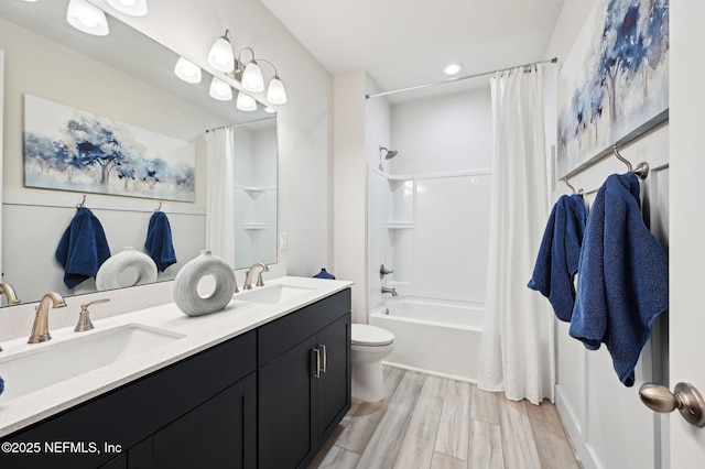 bathroom with toilet, shower / bath combination with curtain, a sink, and wood finished floors