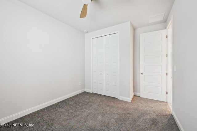 unfurnished bedroom with ceiling fan, carpet floors, a closet, and baseboards