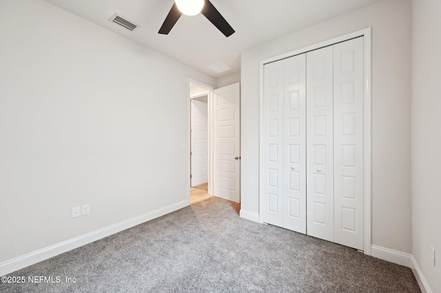 unfurnished bedroom with carpet, a closet, visible vents, and baseboards