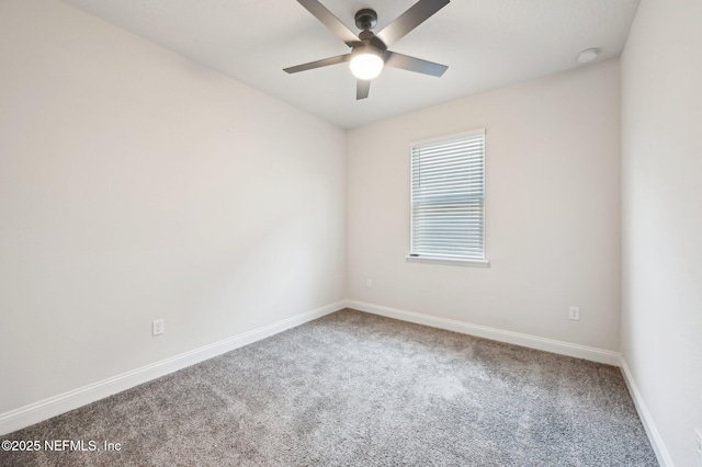 empty room with ceiling fan, carpet floors, and baseboards