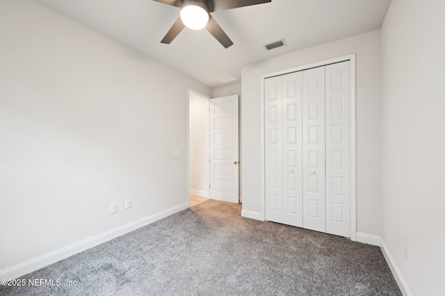 unfurnished bedroom featuring carpet floors, a closet, visible vents, a ceiling fan, and baseboards