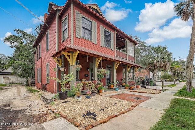 view of front of home featuring a balcony and covered porch