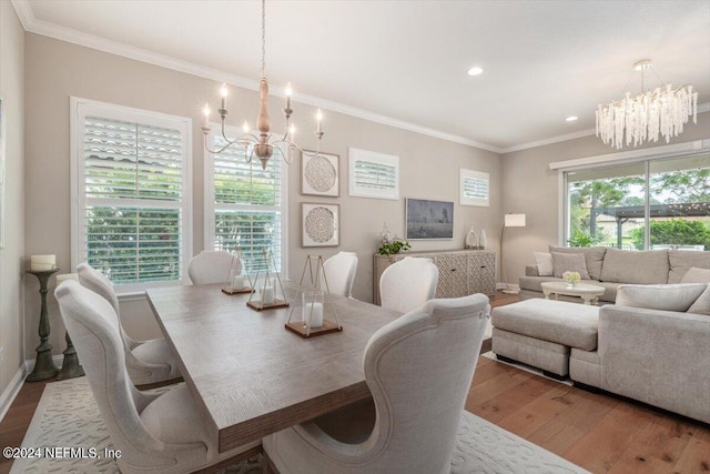 dining room with a chandelier, light hardwood / wood-style floors, and crown molding