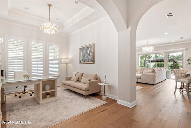 interior space featuring a notable chandelier, a wealth of natural light, and light wood-type flooring