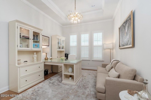 office featuring ornamental molding, a tray ceiling, a chandelier, and light hardwood / wood-style flooring