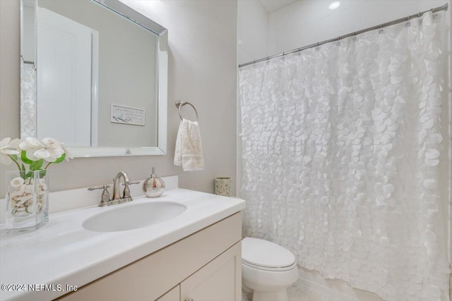 bathroom featuring a shower with curtain, vanity, tile patterned flooring, and toilet