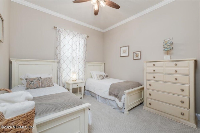 carpeted bedroom with ceiling fan and crown molding