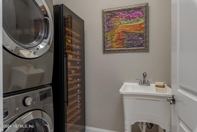 clothes washing area featuring stacked washer and clothes dryer