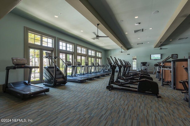 exercise room featuring dark carpet and ceiling fan