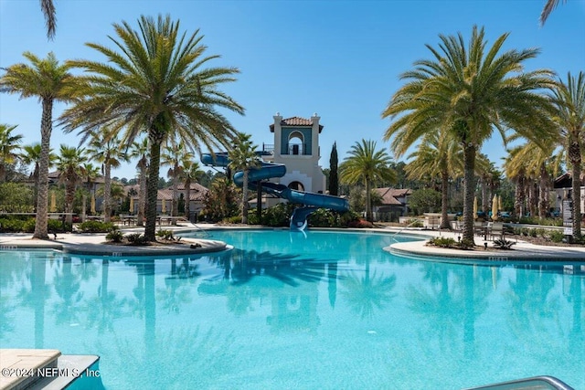 view of swimming pool with a water slide