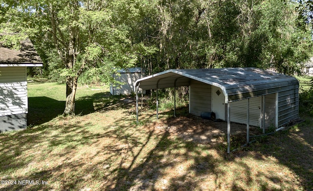 view of yard with a carport and a storage shed